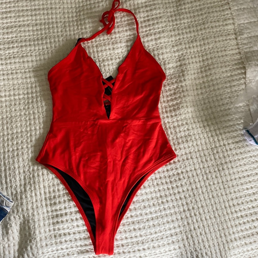 Beautiful red one piece swim. Deep V halter neck cheeky bottoms. Never worn.